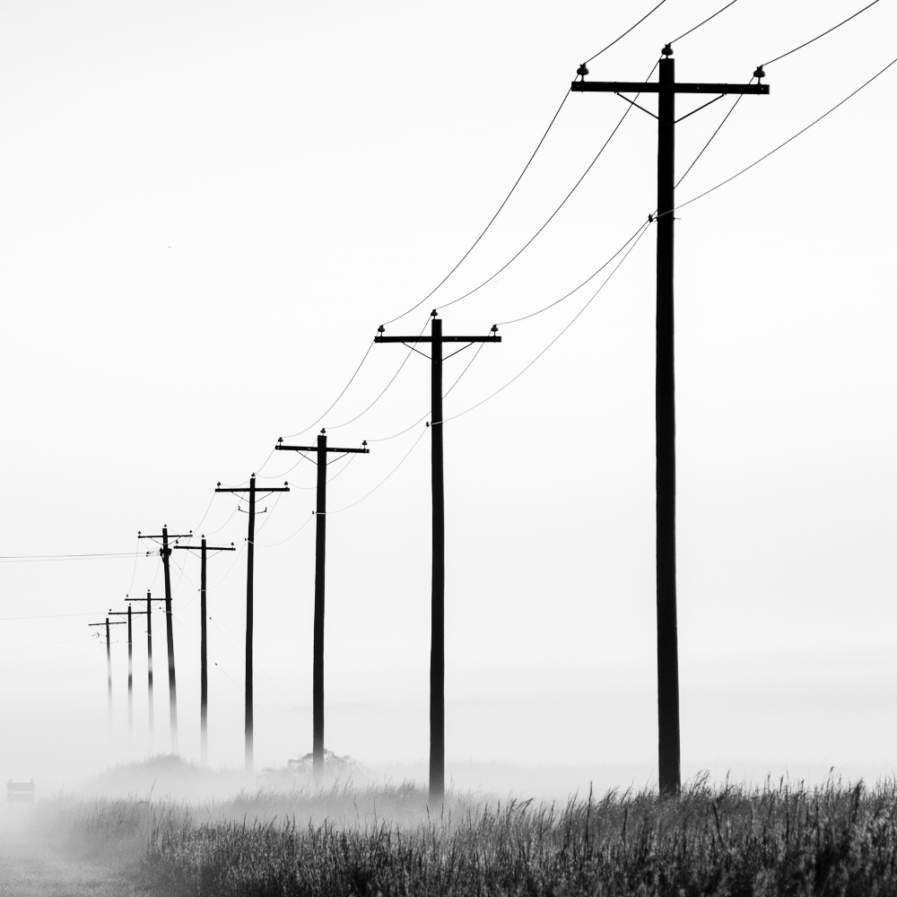 Large power lines running over rural agricultural land
