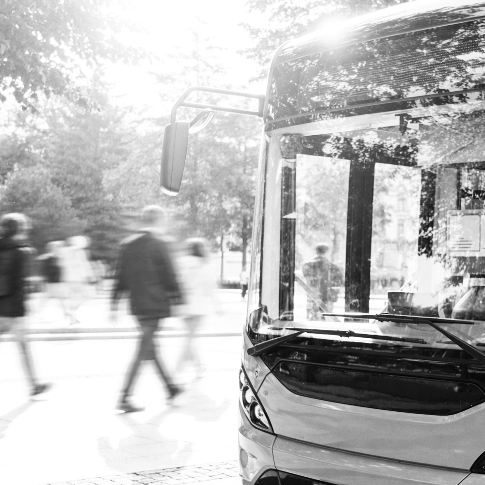 Electric bus picking up passengers in a city