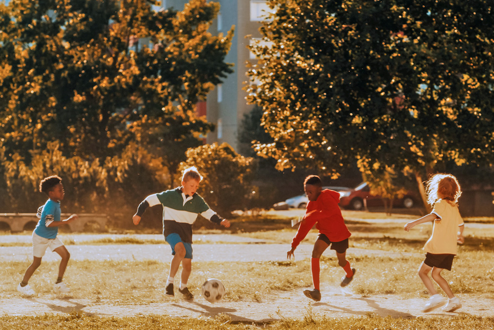 Kids playing soccer outdoors