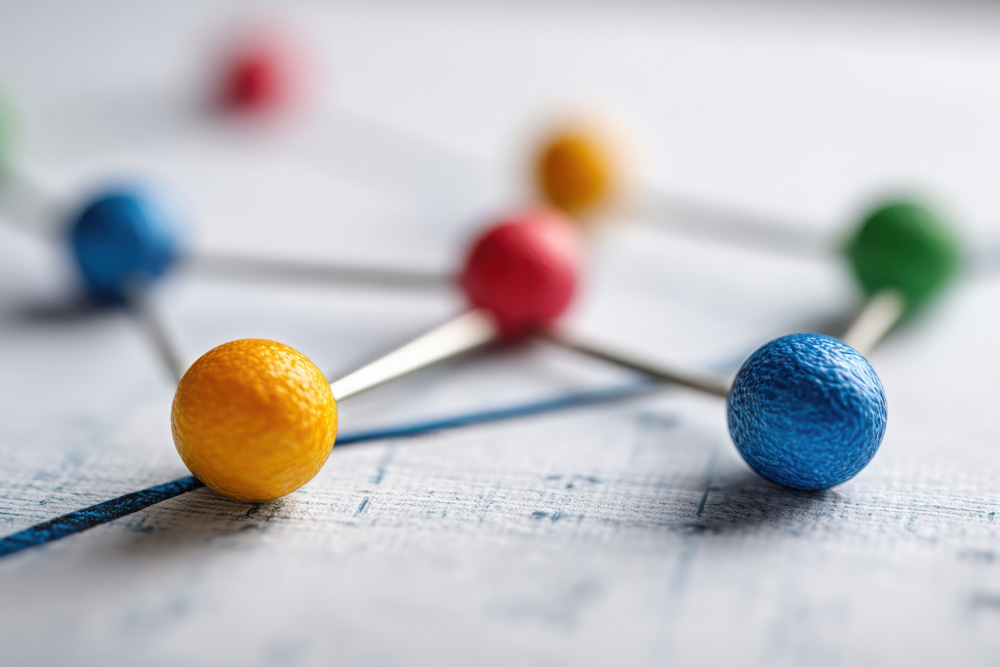 Colorful wooden spheres connected over a map