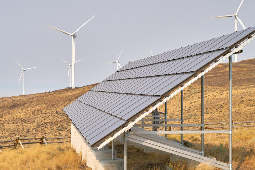 A solar array in western Washington, with wind turbines in the background